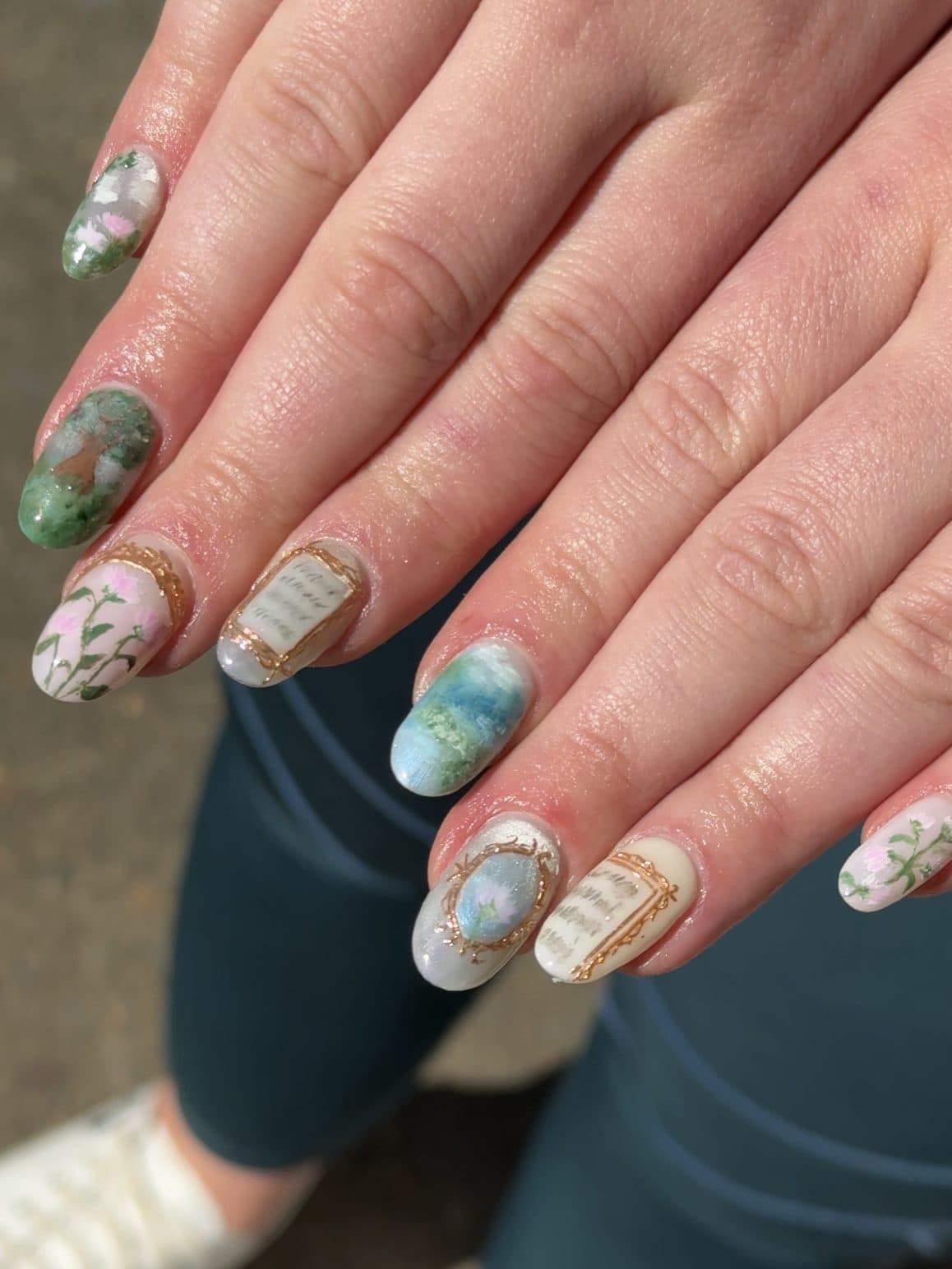 Hand-painted miniature landscape and floral scenes on short almond Gel-X nails