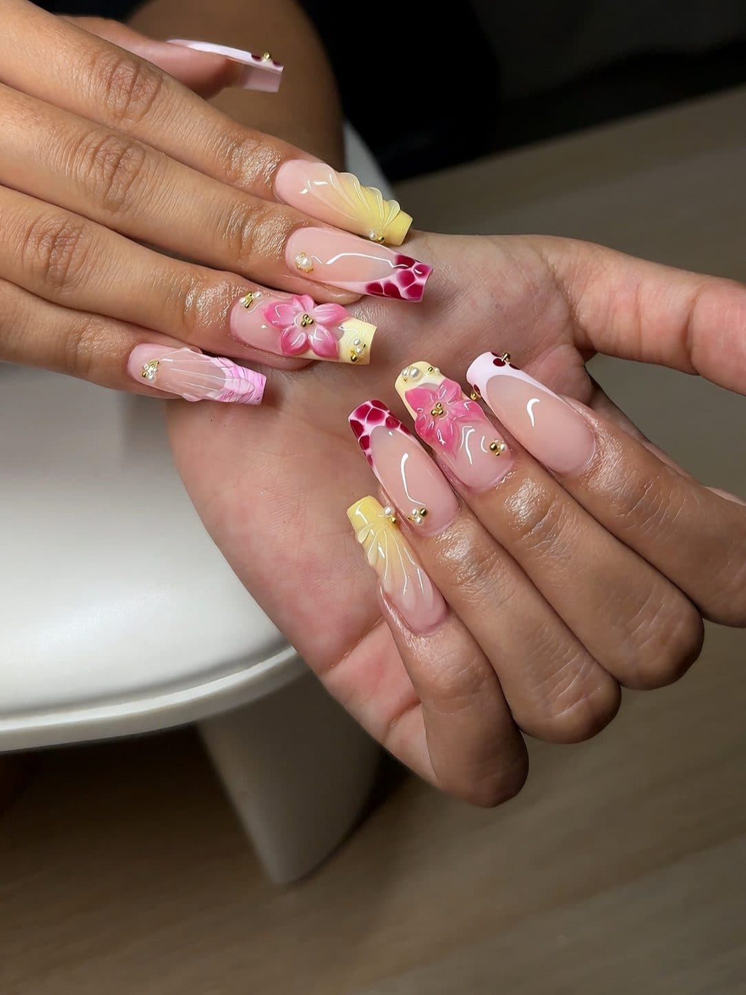 Pastel almond Gel-X set with 3D pink flowers, yellow tips and fine painted details