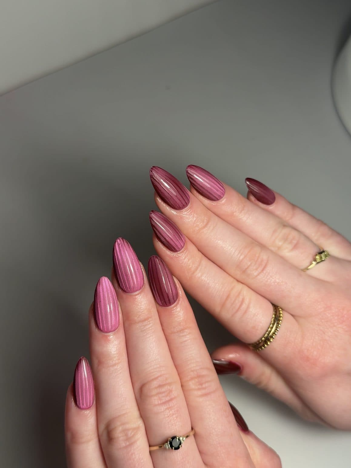 Raspberry pink almond Gel-X nails with a ribbed, textured finish